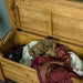 A view of inside the Camden Oak Blanket Box. There are various blankets inside.
