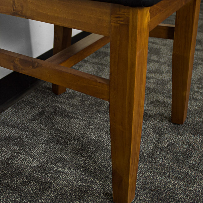 A closer view of the legs of the Hamilton Rimu Stained NZ Pine Dining Chair, as well as the middle brace for extra stability.