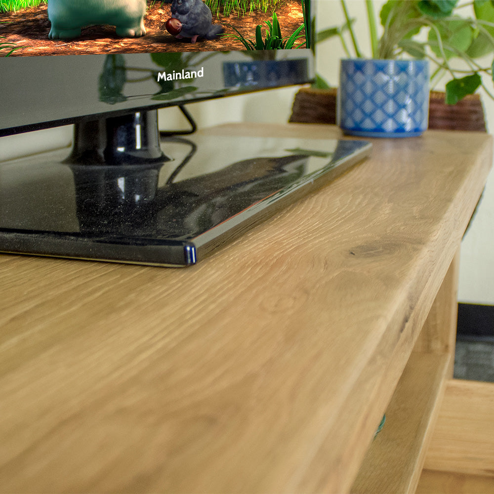 A close up of the top of the Farmhouse Entertainment Unit, showing the wood grain and colour.