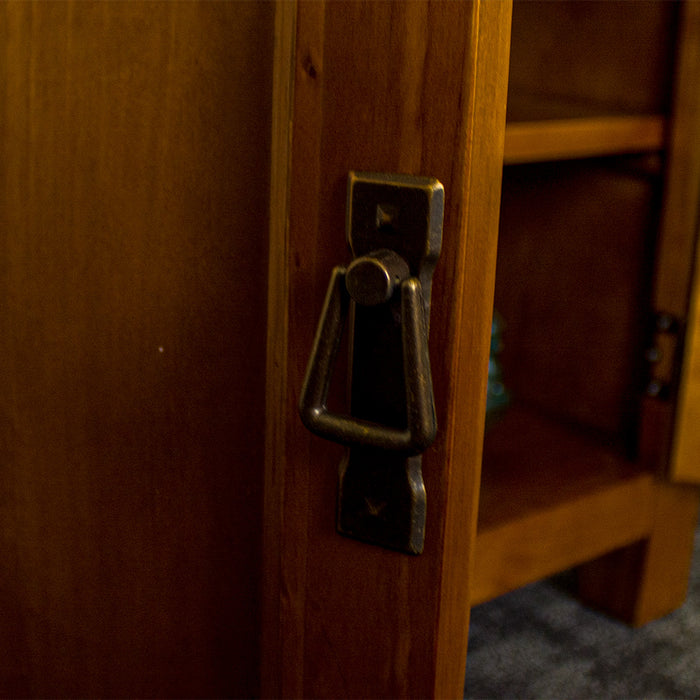 A close up of the door handle on the Montreal Small Pine Buffet