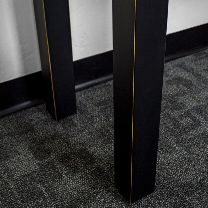 A close up of the leg on the Cascais Black Desk