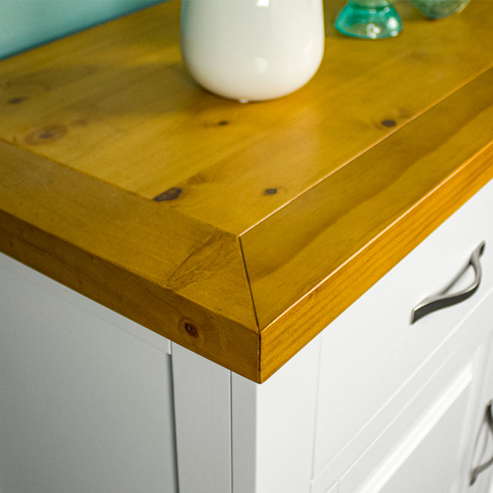 A close up of the top of the Felixstowe Small Pine Buffet (White), showing the wood grain and colour.