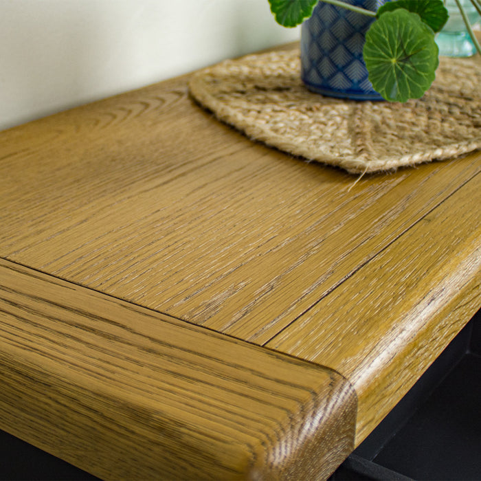 A close up of the top of the Cascais 2-Drawer Hall Table, showing the wood grain and colour.