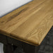 A close up of the top of the Boston Short Oak Bench, showing the wood grain and colour.
