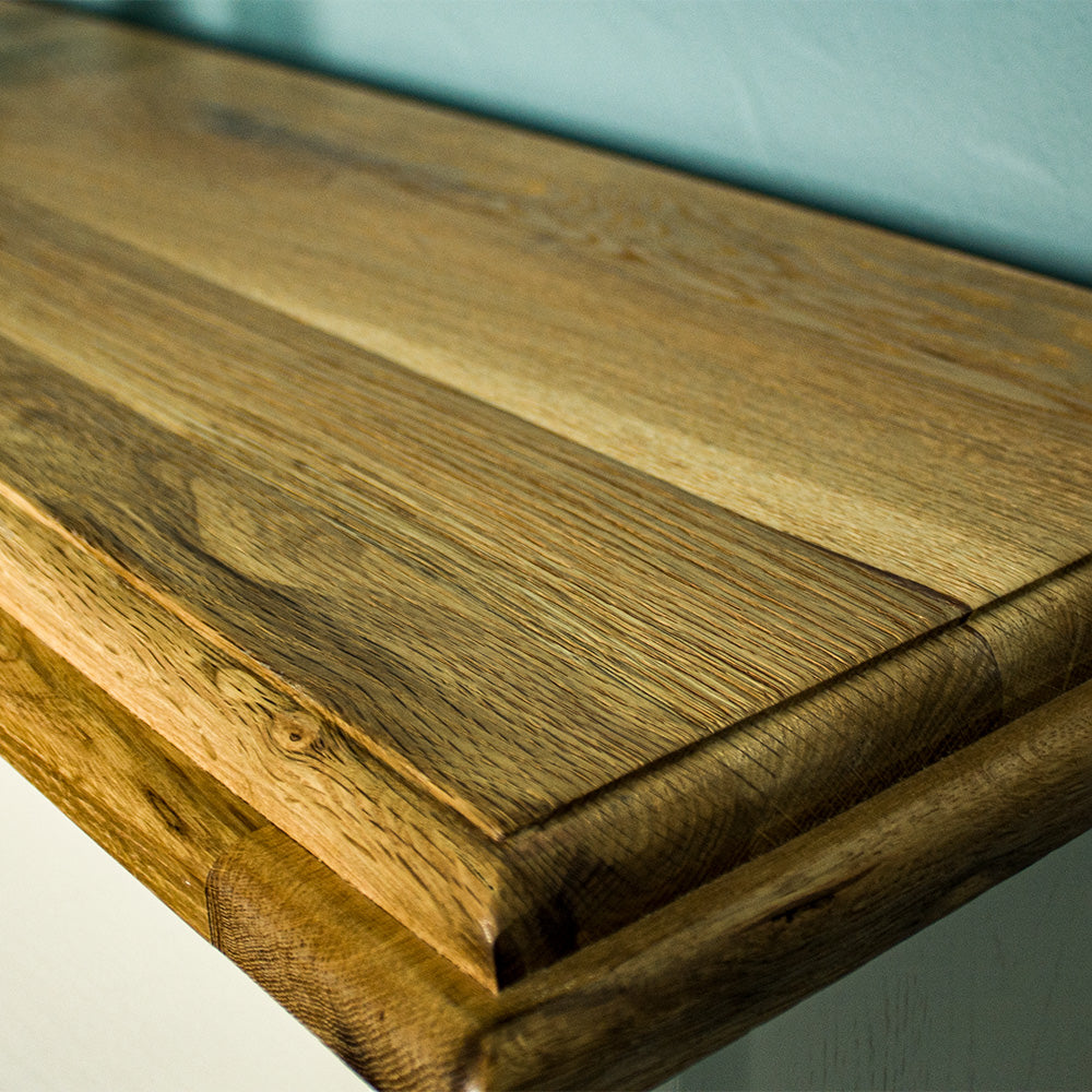 A close up of the top of the Versailles Outback Oak Bookshelf (Off White), showing the wood grain and colour.
