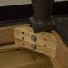 A close up of the screws that securely hold the legs of the Boston Oak Large 2m Dining Table to the body.