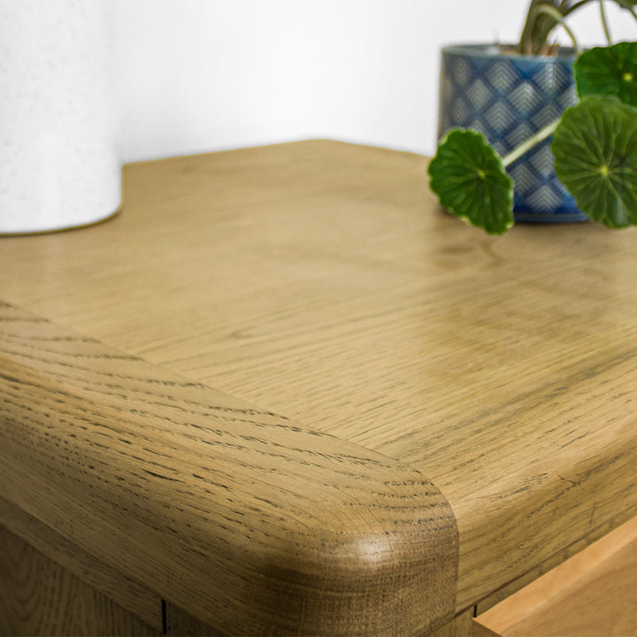 A close up of the top of the Houston Oak Lamp Table, showing the wood grain and colour.