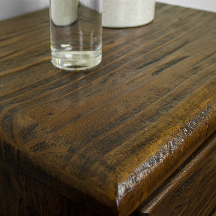 A close up of the top of the Heid Large 3 Drawer Pine Bedside, showing the wood grain and colour.