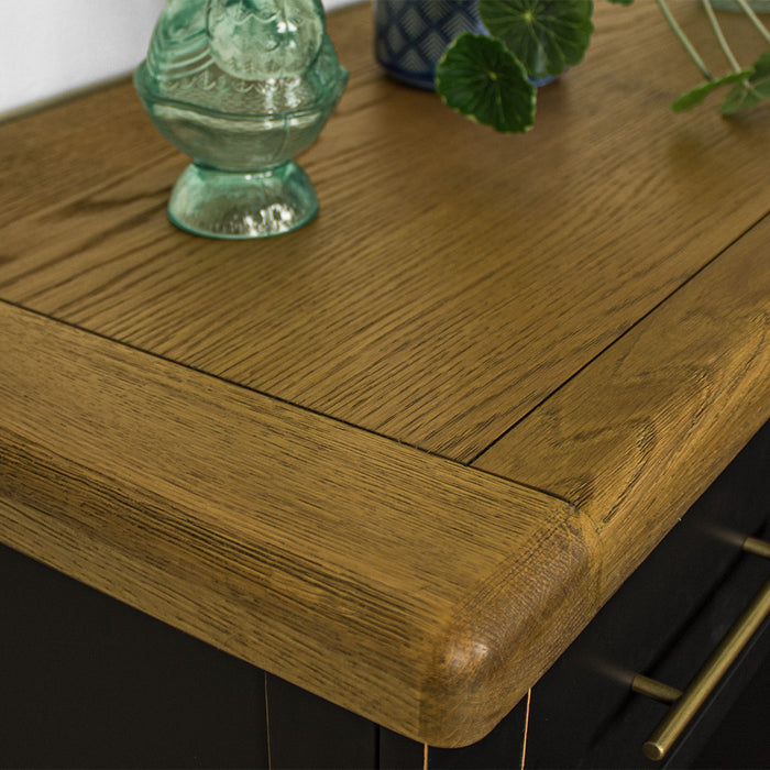 A close up of the top of the Cascais Oak Top Black Tallboy, showing the colour and wood grain.