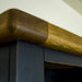 A close up of the top of the Cascais Tall Black Bookcase, showing the wood grain and colour.