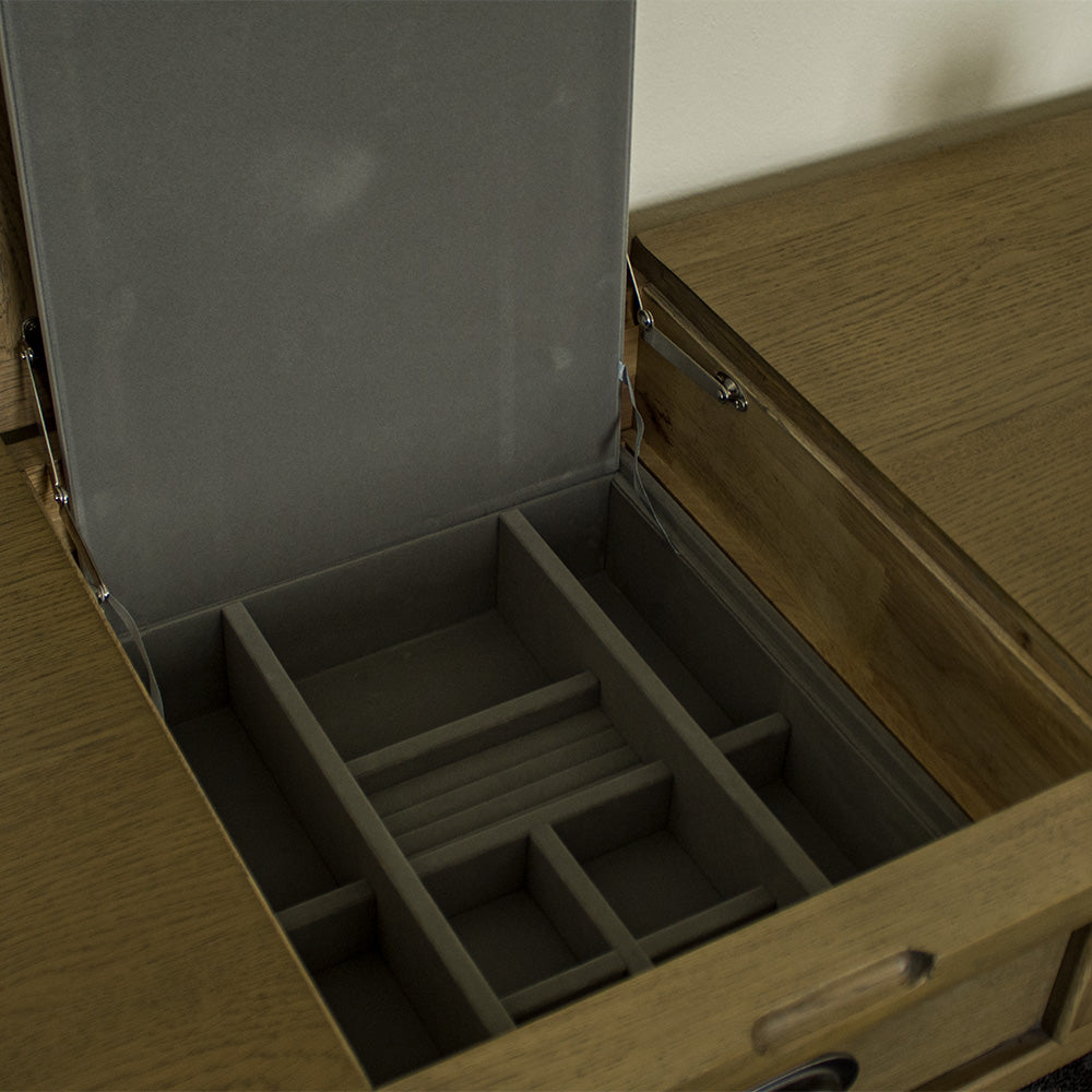 A view of the hidden compartment under the mirror on the Houston Oak Dressing Table With Mirror.